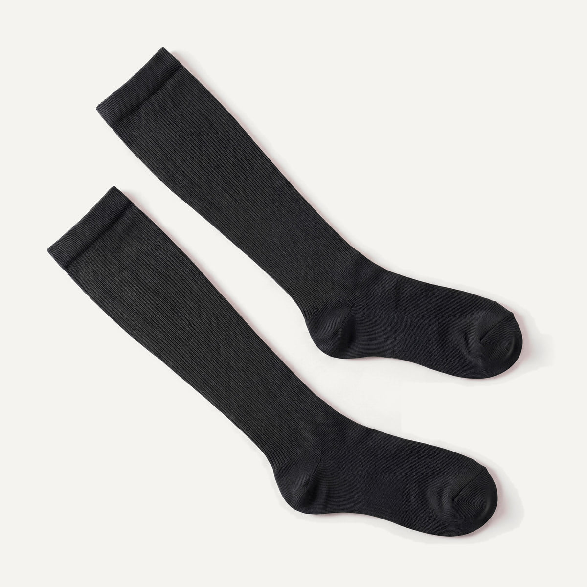 Knee-High Compression Socks in Black, pair laid flat