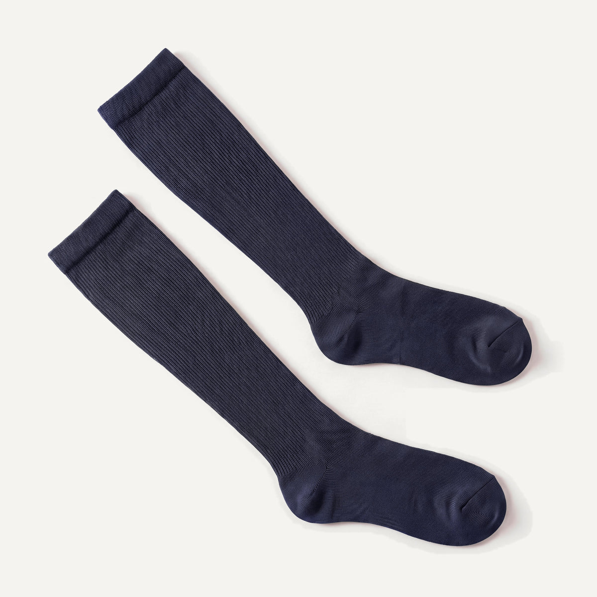 Knee-High Compression Socks in Navy, pair laid flat