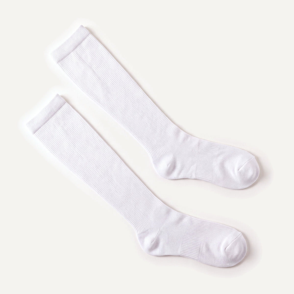 Knee-High Compression Socks in White, pair laid flat