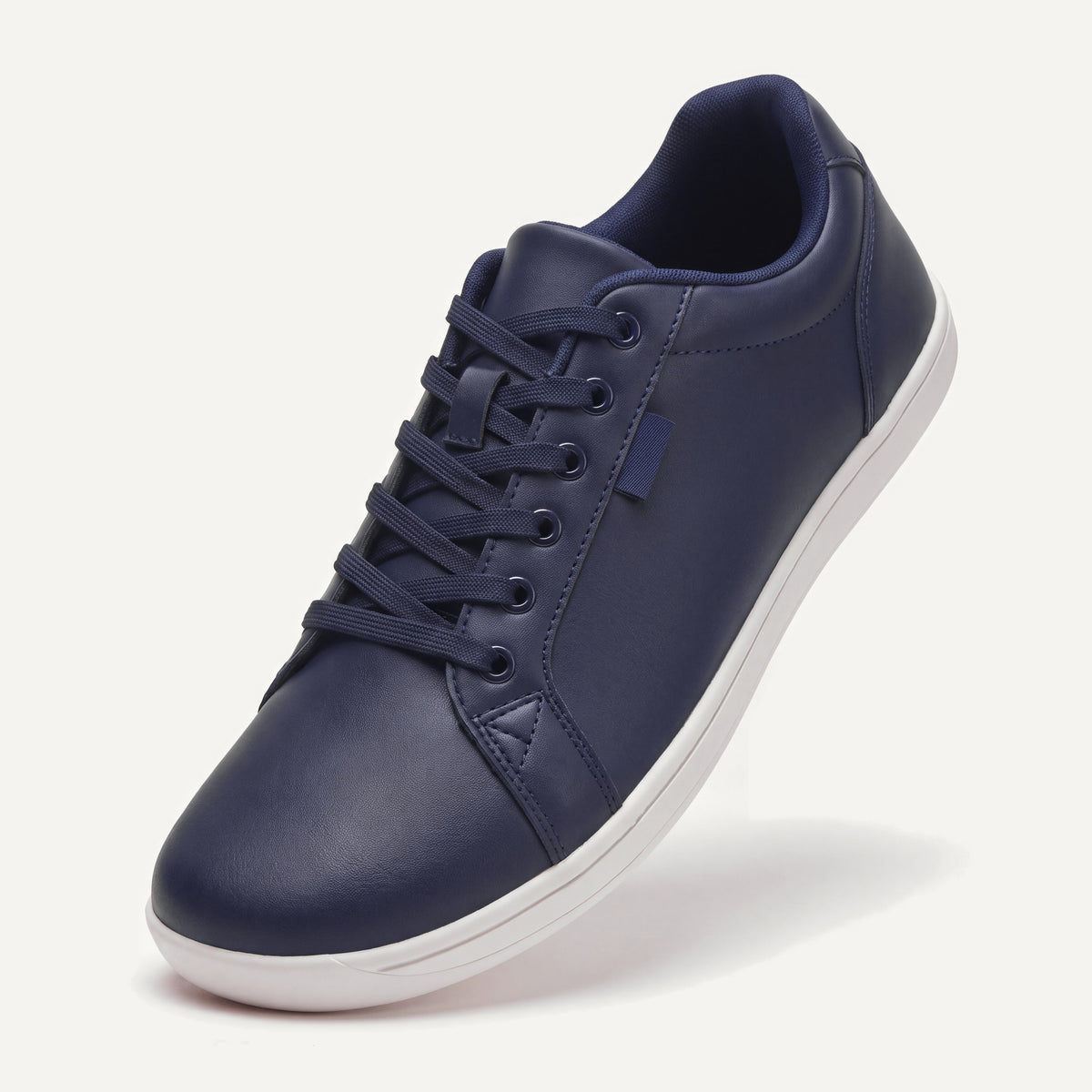 Pelle Vie in Dark Navy, standing on the toe, top view of the laces